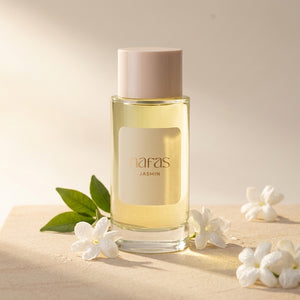 Nafas by Noor Jasmin Extrait de Parfum 100ml bottle surrounded by fresh jasmine blooms and green leaves