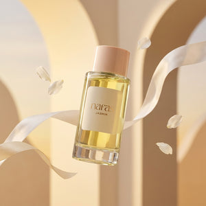 Nafas by Noor Jasmin Extrait de Parfum 100ml bottle floating between cream arches with silk ribbon and jasmine petals