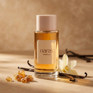 Nafas by Noor Vanilla Extrait de Parfum 100ml bottle beside vanilla pods, orchid bloom and amber resin